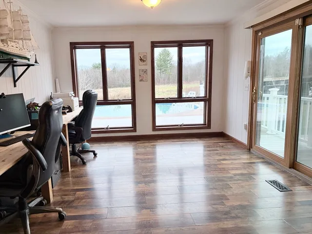 a view of a room with furniture wooden floor and windows