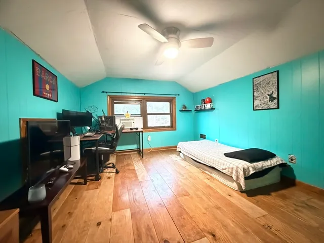 a bed room with furniture and a flat screen tv