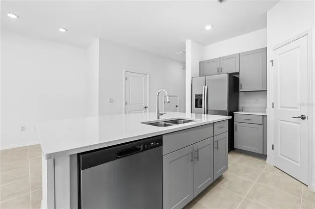 a kitchen with a sink stainless steel appliances and cabinets
