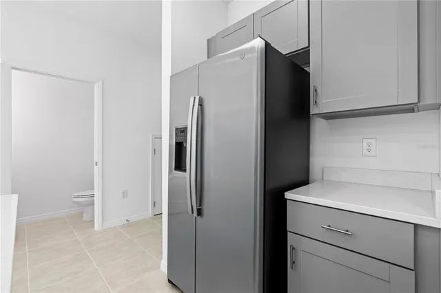 a kitchen with a refrigerator and a stove