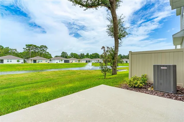 a house with green field in front of it