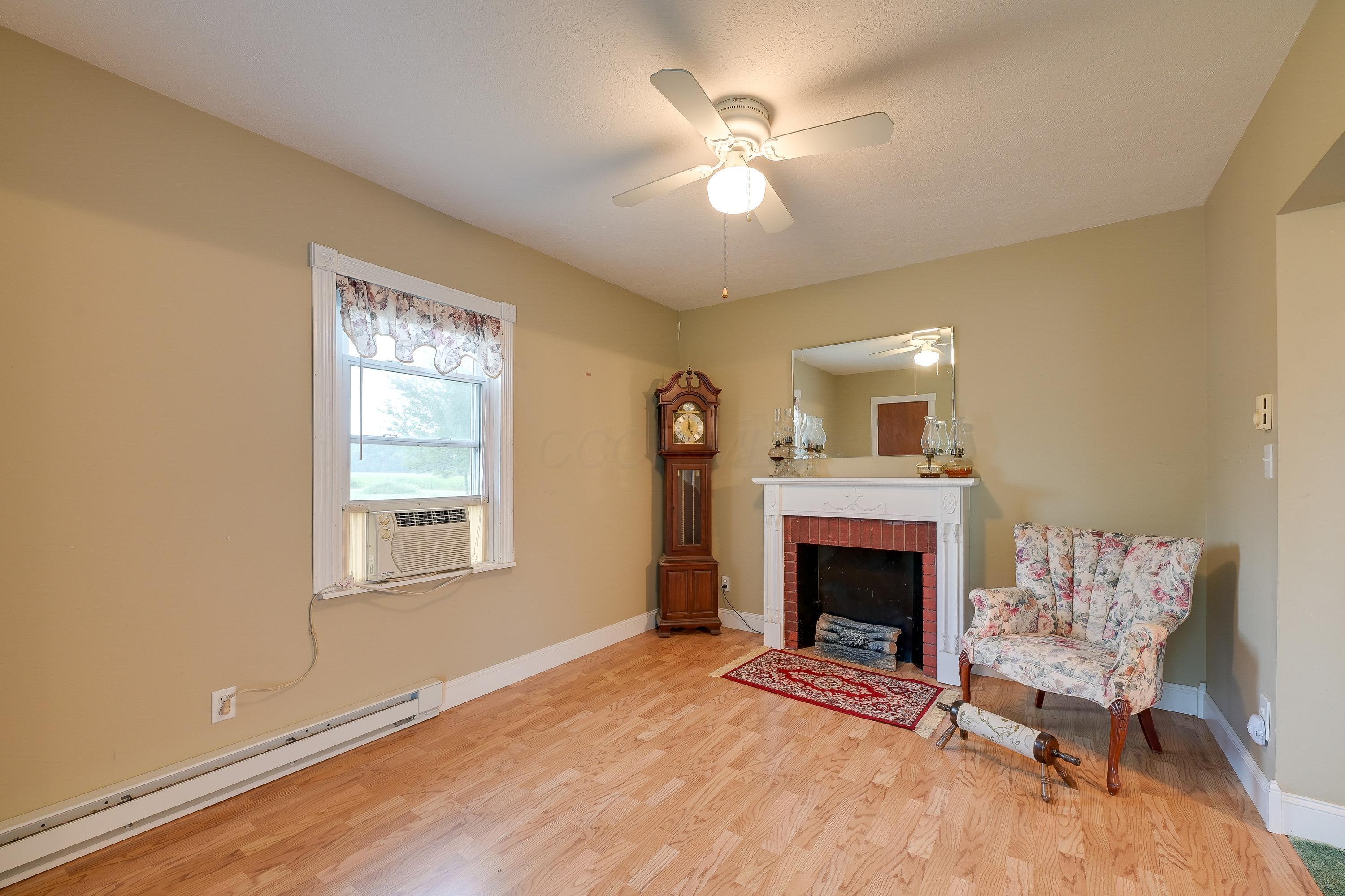 19834 Botkins Road Jackson Center, OH 45334 - Photo 7 of 32 Light wood-finish flooring complements the neutral wall color