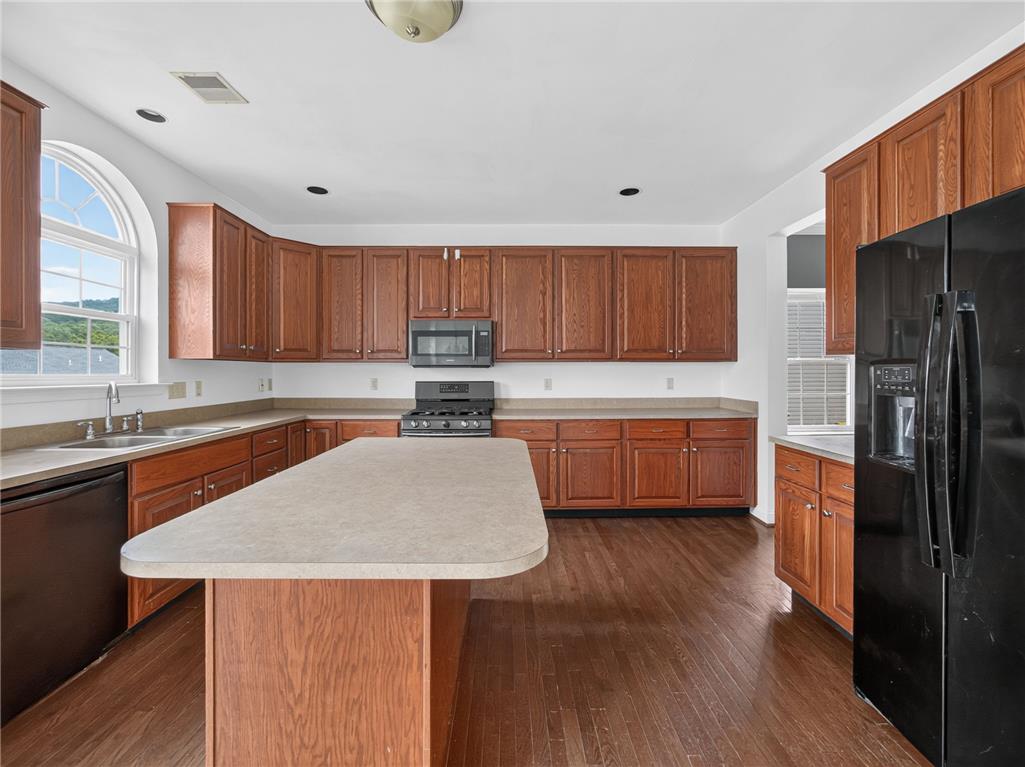 3821 Rittenhouse Road Lower Macungie Township, PA 18062 - Photo 32 of 62 A generously sized kitchen featuring rich wood cabinetry and a central island with abundant counter space.