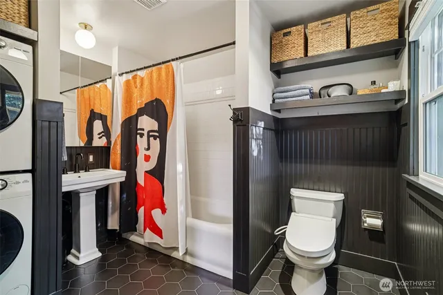 a bathroom with a toilet sink and mirror