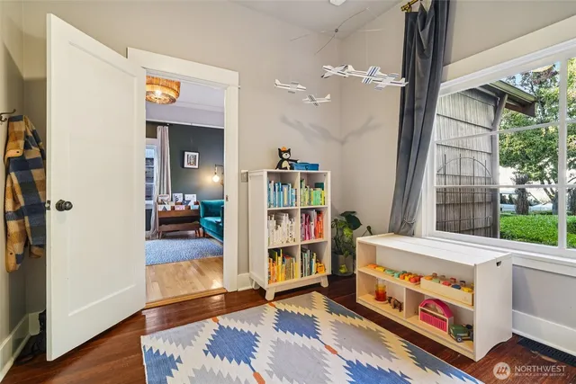a living room with furniture and a book shelf