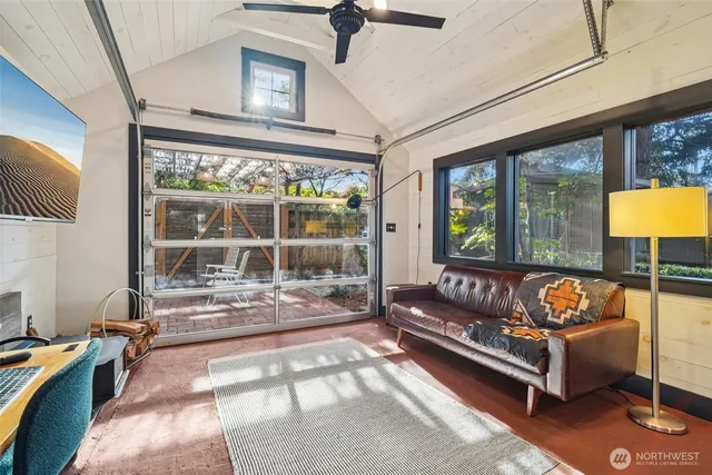 a living room with furniture and a floor to ceiling window
