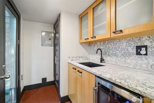 a kitchen with sink and mirror