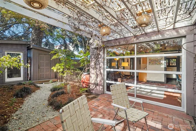 a view of backyard with a table and chair and wooden fence