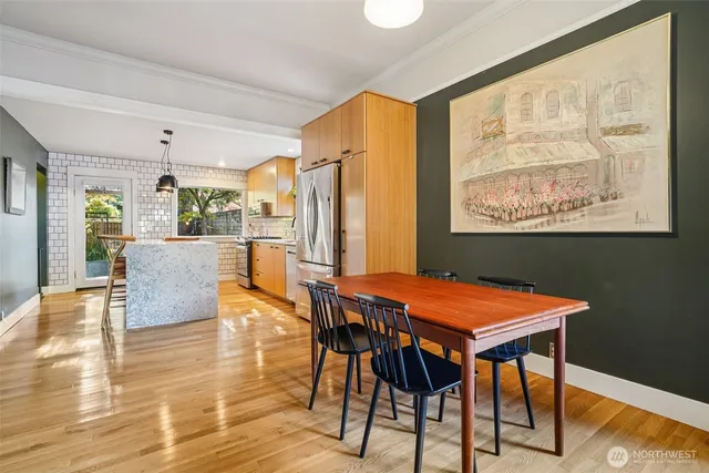 a dining room with furniture and wooden floor