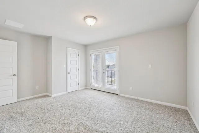 a view of an empty room with closet area