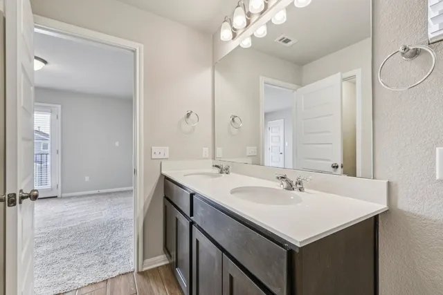 a bathroom with a sink double vanity and a mirror