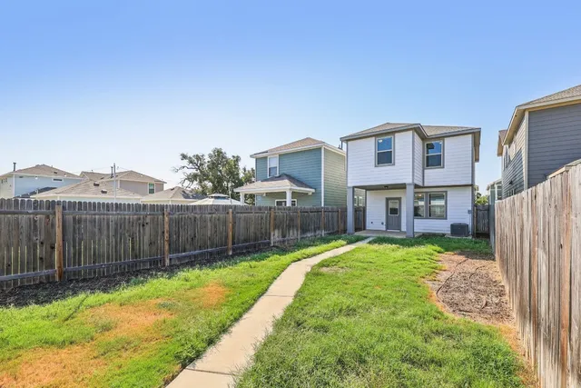 a view of a house with a yard and furniture