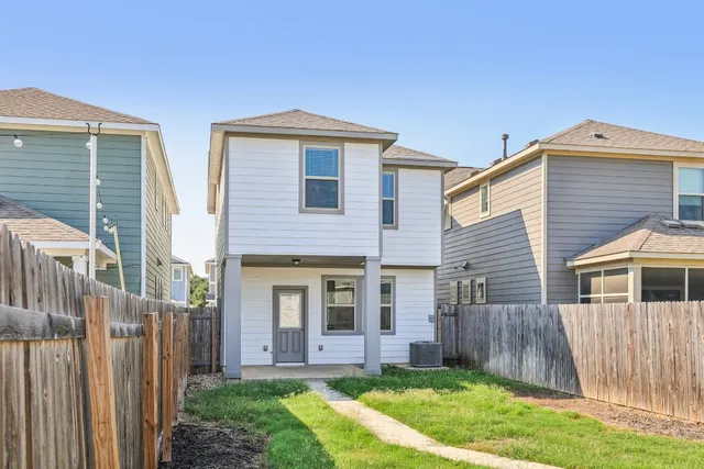 a front view of house with a garden