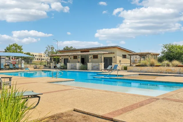 a view of house with swimming pool outdoor seating