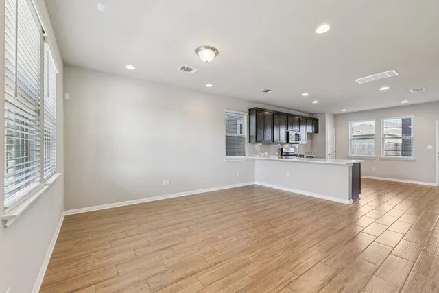 a view of kitchen and hall with wooden floor