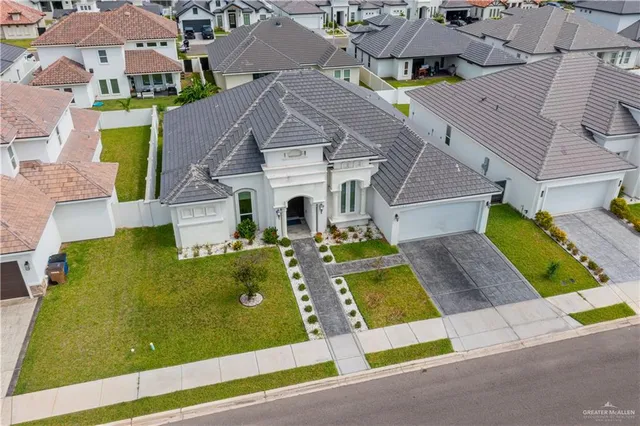 an aerial view of residential houses with yard