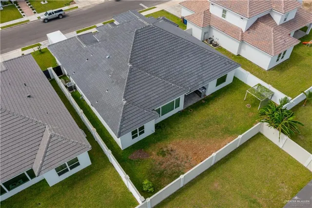 a aerial view of a house with a yard and potted plants