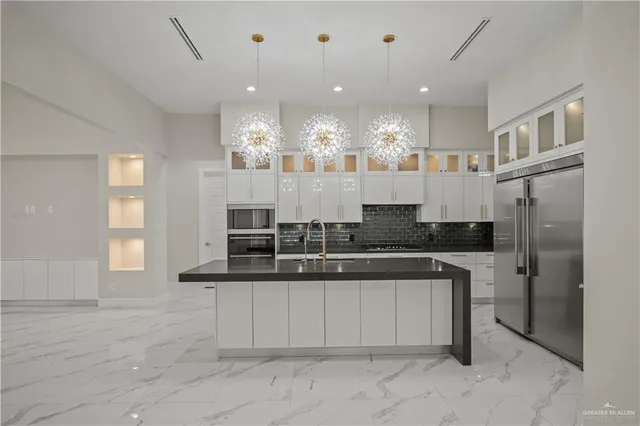 a large white kitchen with a large window