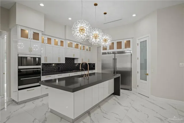 a kitchen with granite countertop a stove and a microwave