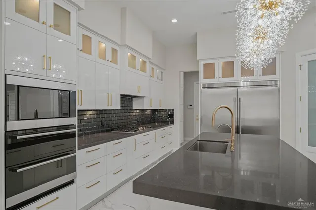 a kitchen with stainless steel appliances granite countertop a sink and cabinets