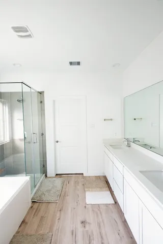 a bathroom with a sink a mirror and a bathtub