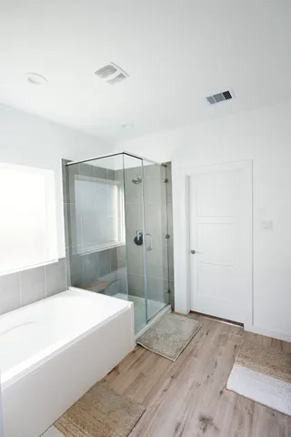 a spacious bathroom with a bathtub and a shower