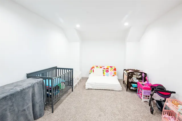 a bedroom with lots of white furniture