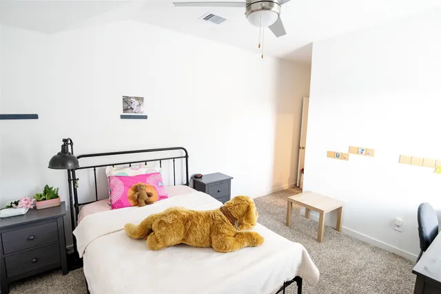 a bedroom with a bed and a table