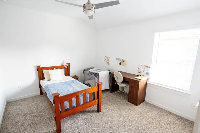 a bedroom with 2 bed and a window