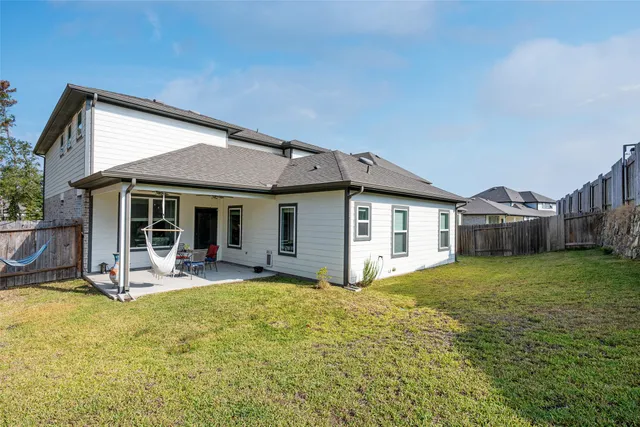a view of a house with backyard porch and sitting area