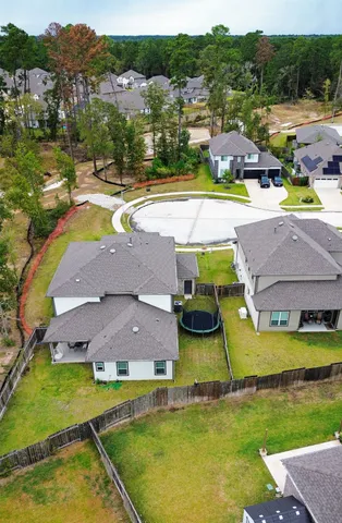 an aerial view of residential houses with outdoor space and swimming pool