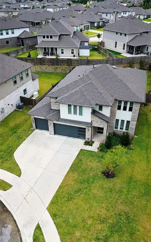 an aerial view of a house with a garden and lake view