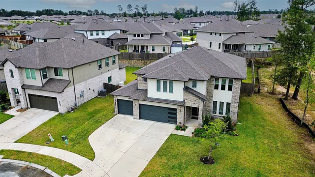 an aerial view of a house with swimming pool and furniture