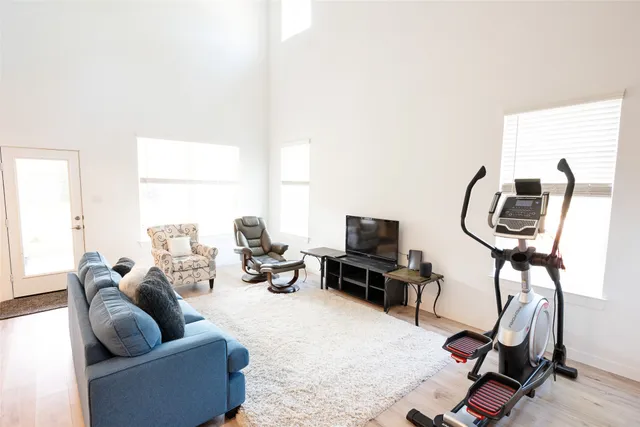 a living room with furniture a rug and a window