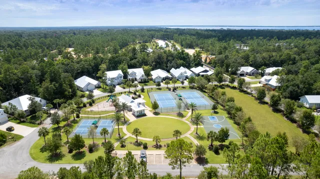 an aerial view of a residential houses with outdoor space and street view