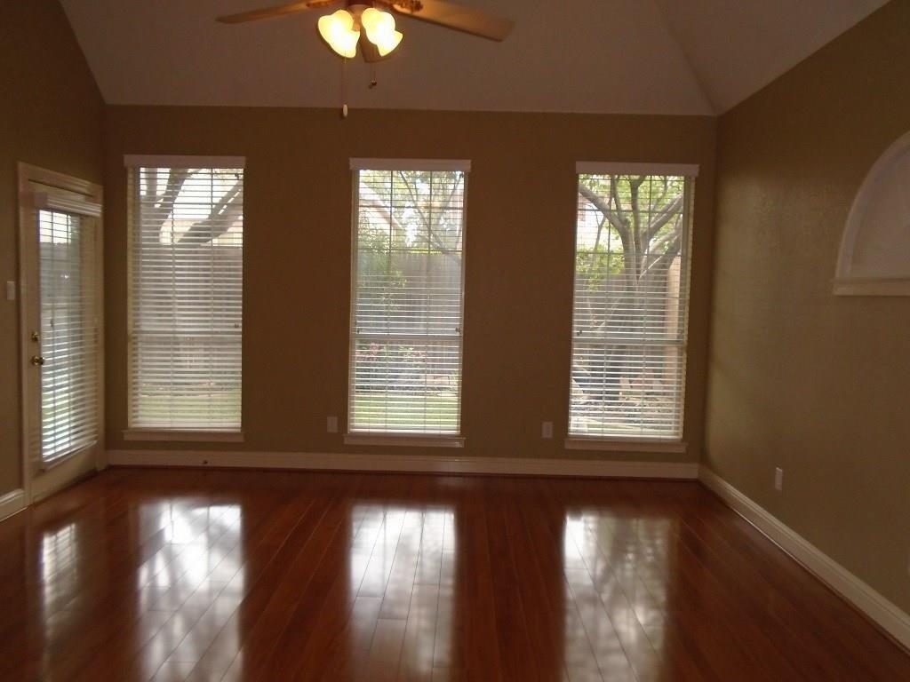 6905 Vista Ridge Court Fort Worth, TX 76132 - Photo 11 of 13 a view of an empty room with wooden floor and a window