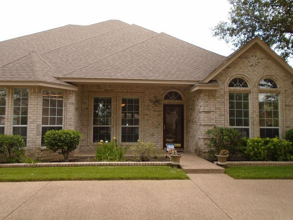 6905 Vista Ridge Court Fort Worth, TX 76132 - Photo 3 of 13 a front view of a house with a yard and potted plants