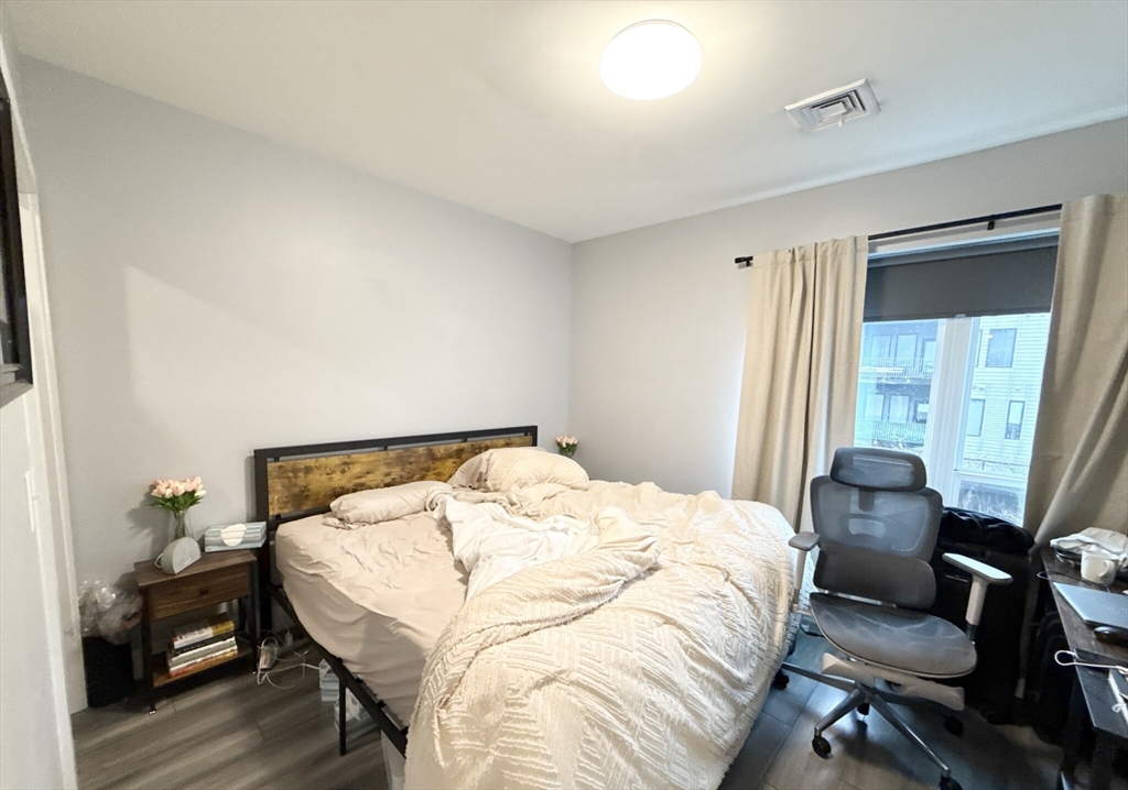 55 West Fifth Street, Unit 301 Boston, MA 02127 - Photo 3 of 11 a bedroom with a bed and a window