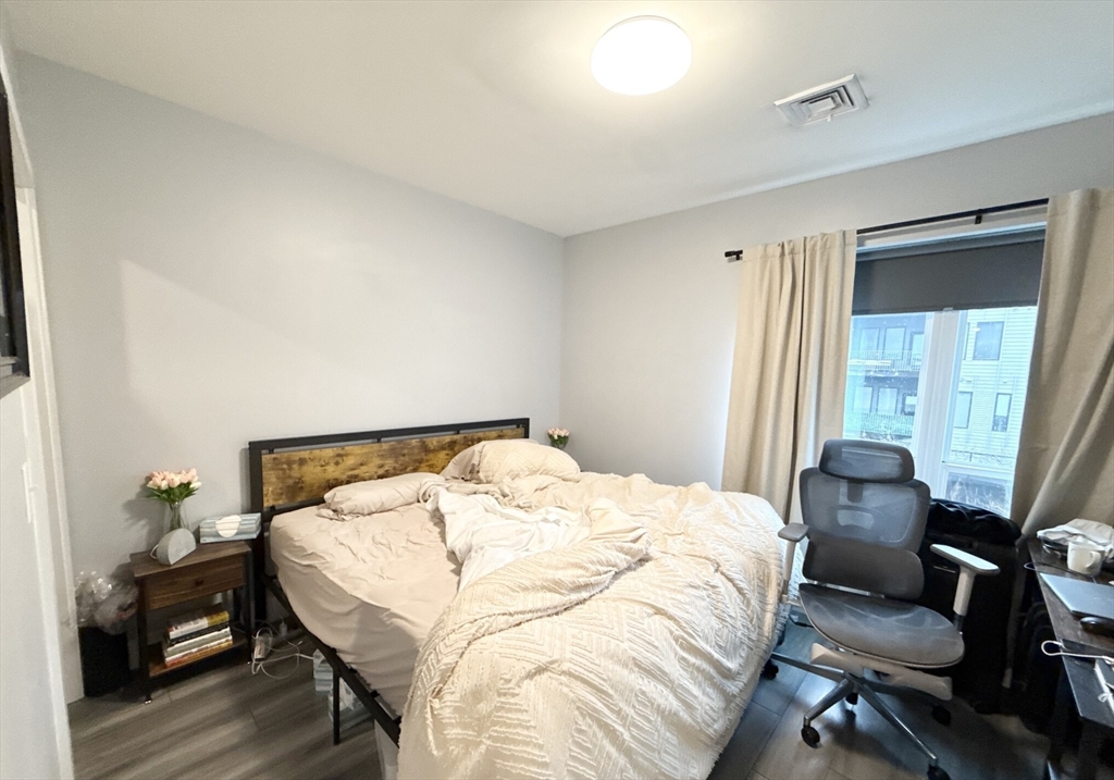 55 West Fifth Street, Unit 301 Boston, MA 02127 - Photo 4 of 11 a bedroom with a bed and a window