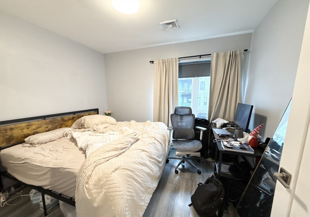 55 West Fifth Street, Unit 301 Boston, MA 02127 - Photo 5 of 11 a bedroom with bed and a window