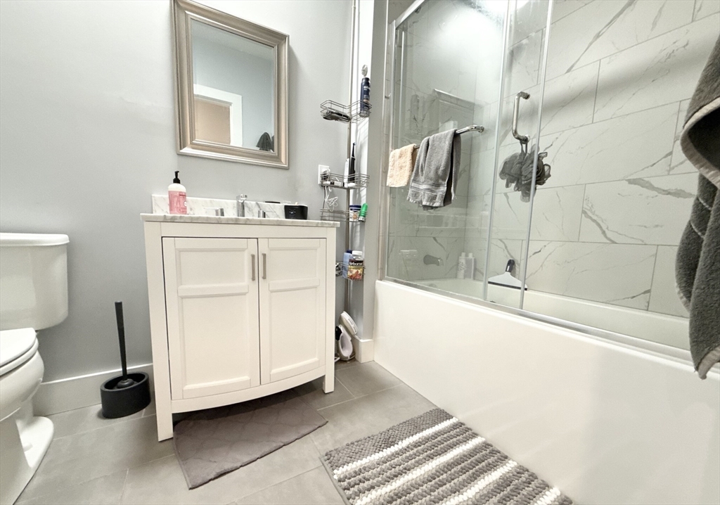 55 West Fifth Street, Unit 301 Boston, MA 02127 - Photo 6 of 11 a bathroom with a sink a toilet and shower