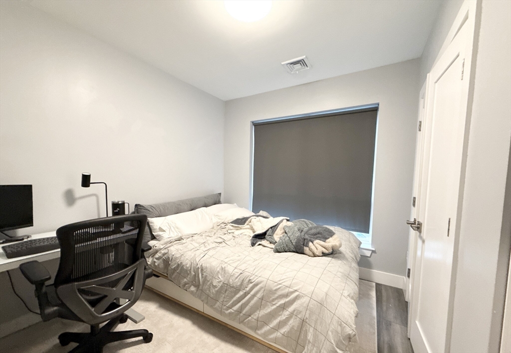55 West Fifth Street, Unit 301 Boston, MA 02127 - Photo 8 of 11 a bedroom with a bed and a desk