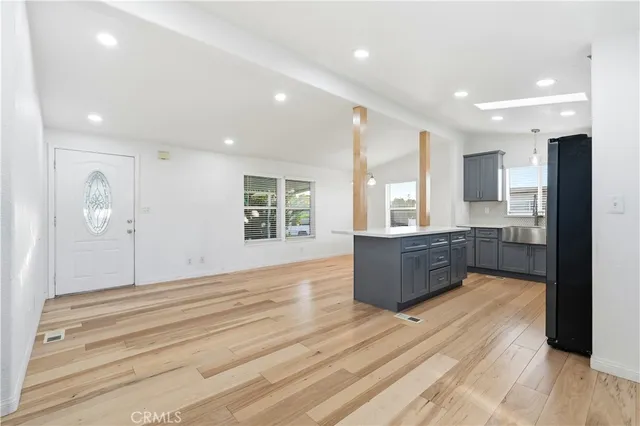 a room with a couch and a view of kitchen