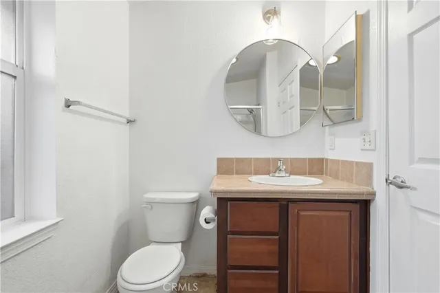 a bathroom with a sink toilet and mirror