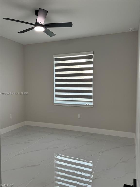 2902 49th Street Southwest Lehigh Acres, FL 33976 - Photo 19 of 26 a view of empty room with a ceiling fan