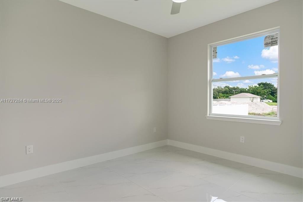 2902 49th Street Southwest Lehigh Acres, FL 33976 - Photo 20 of 26 an empty room with a window