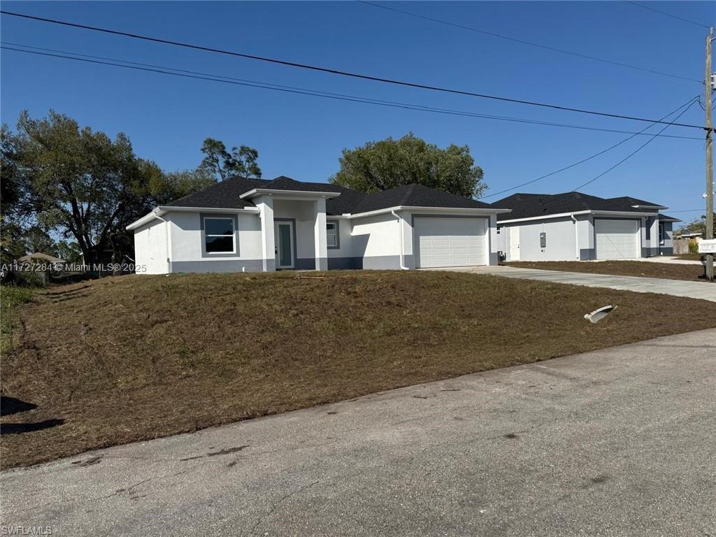 2902 49th Street Southwest Lehigh Acres, FL 33976 - Photo 2 of 26 front view of a house with a street