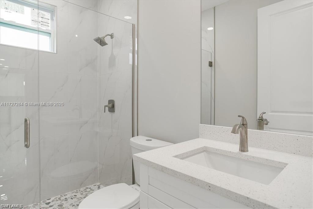 2902 49th Street Southwest Lehigh Acres, FL 33976 - Photo 21 of 26 a bathroom with a sink toilet and shower
