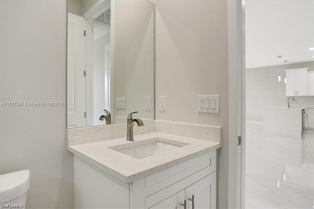 2902 49th Street Southwest Lehigh Acres, FL 33976 - Photo 22 of 26 a bathroom with a sink and a mirror
