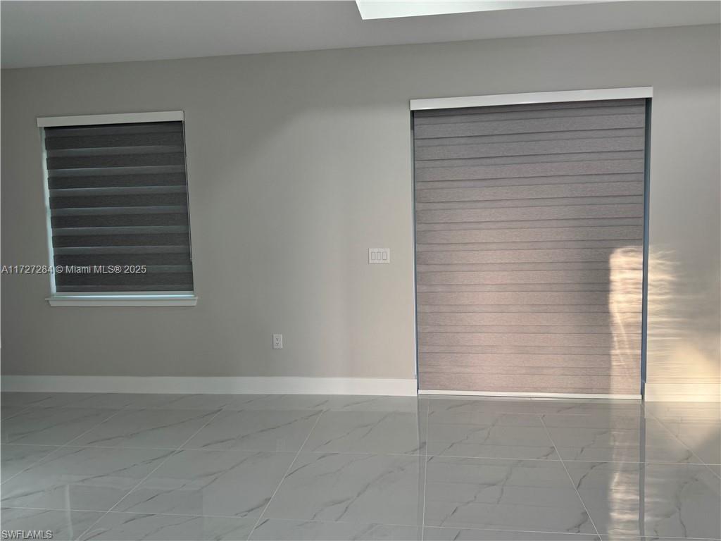 2902 49th Street Southwest Lehigh Acres, FL 33976 - Photo 7 of 26 a view of an empty room with a window